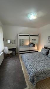 a bedroom with a large bed and a chair at Two bedroom flat - Hyper Center Brussels in Brussels