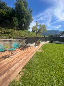 a patio with two chairs and a table in a yard at Villa Coustete in Bôo-Silhen