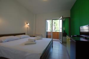 a bedroom with a bed with towels on it at Pansion HRGA in Vodice