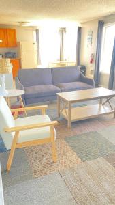 a living room with two tables and a couch at Ocean Shores Inn & Suites in Ocean Shores