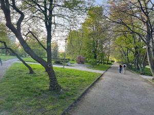 two people walking down a path in a park at Żeromskiego 2024 in Gdynia +3 photos
