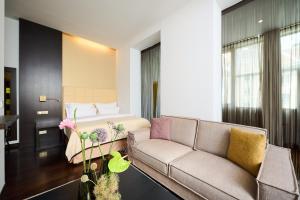 a living room with a couch and a bed at MyPlace Premium Apartments in Vienna