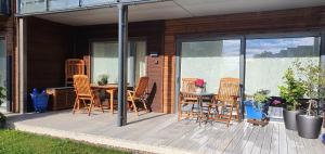 a patio with a table and chairs on a deck at Entire Home - Unique Quiet Quality Near the Sea in Horten