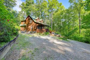 an image of a log cabin in the woods at Pet-Friendly Bryson City Cabin with Fire Pit and Deck! in Bryson City