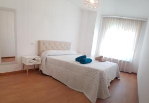 a bedroom with a bed with a blue towel on it at Taboada Sacra Home in Taboada +3 photos