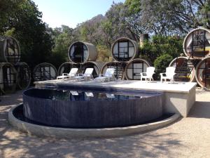 a fountain with chairs and tables in a park at Tubohotel in Tepoztlán