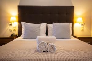 a hotel room with two towels on a bed at Aktaion Resort in Gythio