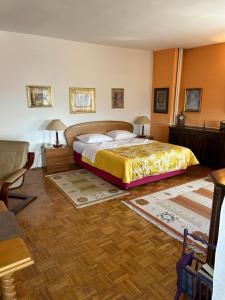 a bedroom with a bed and two tables and two lamps at Hondo Rooms & Apartments in Sarajevo