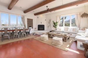 a living room with a table and a couch at Original Homestead Cabin with shared pool in Joshua Tree