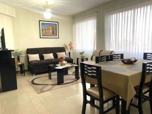 a living room with a table and a couch at El Sosiego en Cochabamba in Cochabamba