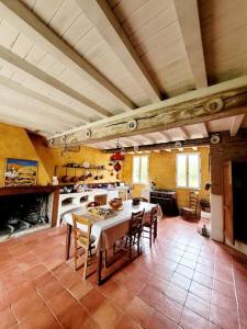 a large kitchen with a table and chairs in it at Domaine d'en serres, 15th century castle in Saint-Marcel-Paulel