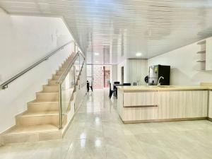 a hallway with a staircase in a house at Casa colonial - Jacuzzi - cerca al parque principal - lundry - Tv in Santa Fe de Antioquia +24 photos