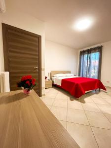 a bedroom with a bed with a red blanket on it at B&B LE LUCI Appartamento al primo piano interno 1 in Vasto