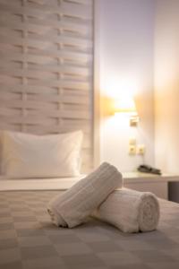 a towel laying on a bed in a bedroom at Aktaion Resort in Gythio