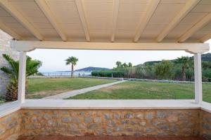 a porch with a view of the ocean at Aktaion Resort in Gythio