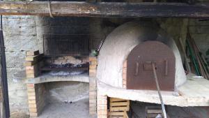 a large brick oven with a door on it at Appartamento Loiacono - Seaview appartaments in Ricadi