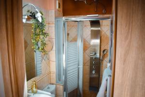a shower with a glass door in a bathroom at Estevi Apartment in Kavala +19 photos