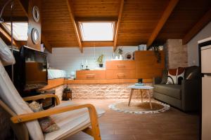 a living room with a couch and a tv at Estevi Apartment in Kavala