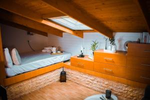 a attic bedroom with a bed and a skylight at Estevi Apartment in Kavala