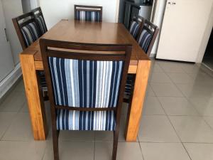 a wooden dining room table with six chairs at Hostel Martina SPExpo 100m in Sao Paulo