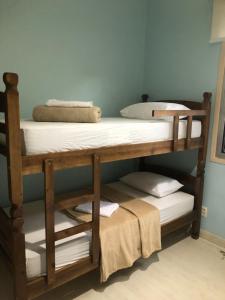 two bunk beds in a room with towels on them at Hostel Martina SPExpo 100m in Sao Paulo
