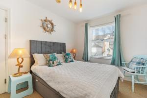 a bedroom with a bed and a window at The Pennines - Close to town beach and shops in Tenby
