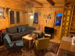 a living room with a couch and a table at Vikendica Čarolija in Berane