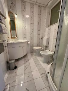 a bathroom with a toilet and a sink at MB apartment Bled in Bled +20 photos