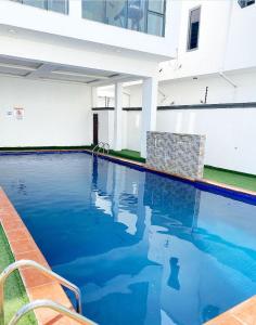 a swimming pool with blue water in a building at BOAD Ventures in Lekki