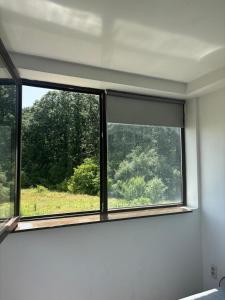a window in a room with a view of a field at Magurele Forest in Măgurele