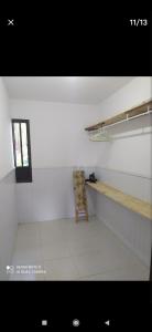 a white room with a shelf and a window at Flor de Lis in Salvador