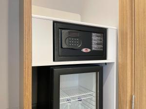 a microwave oven sitting on top of a refrigerator at Holiday Inn Express - Ankara - Airport by IHG in Ankara