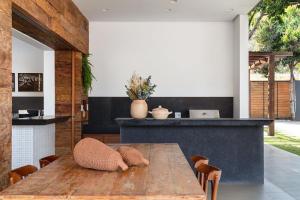 a dining room with a wooden table and chairs at Pousada Noah in Capitólio +27 photos