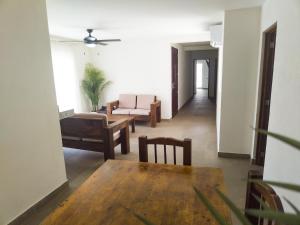 a living room with a table and a couch at Departamento Concha de Mar in Puerto Vallarta +6 photos