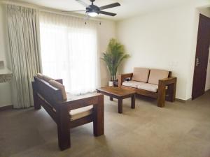 a living room with a couch and a chair at Departamento Concha de Mar in Puerto Vallarta