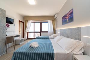 Postel nebo postele na pokoji v ubytování Hotel Galf