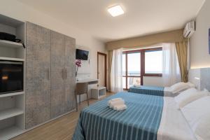 Postel nebo postele na pokoji v ubytování Hotel Galf