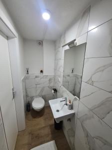 a white bathroom with a toilet and a sink at No name in Jajce +30 photos