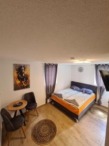 a bedroom with a bed and a table and chairs at No name in Jajce