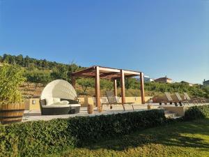 a group of chairs and a gazebo in a yard at Quinta do Retiro in Felgar