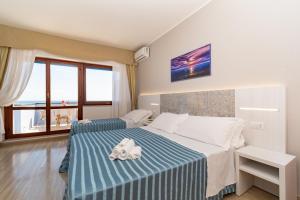 Postel nebo postele na pokoji v ubytování Hotel Galf