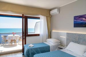 Postel nebo postele na pokoji v ubytování Hotel Galf