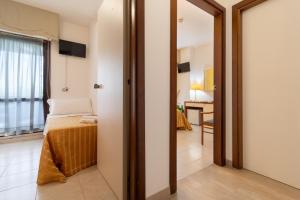 Postel nebo postele na pokoji v ubytování Hotel Galf
