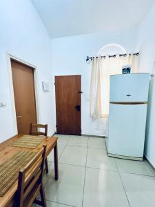 Il comprend une cuisine équipée d'un réfrigérateur et d'une table. dans l'établissement Квартира С Балконом Для Отдыха!, à Haïfa