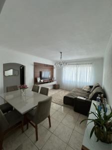a living room with a couch and a table at Vista ao mar no Gonzaga in Santos