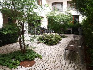 a bench in a courtyard with a building at Stara Praga in Warsaw