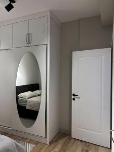 a bedroom with a mirror next to a bed at Muzdeniz Life in Gazipasa +12 photos