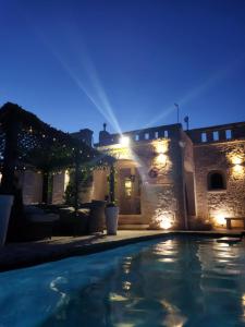a villa with a swimming pool at night at Villa Brachychiton in Ostuni