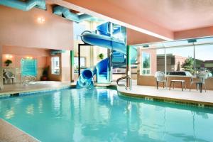 a swimming pool with a slide in a hotel at Days Inn by Wyndham Calgary Airport in Calgary