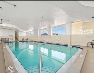 a large swimming pool with blue water in a building at Oceanfront Oasis in Daytona Beach